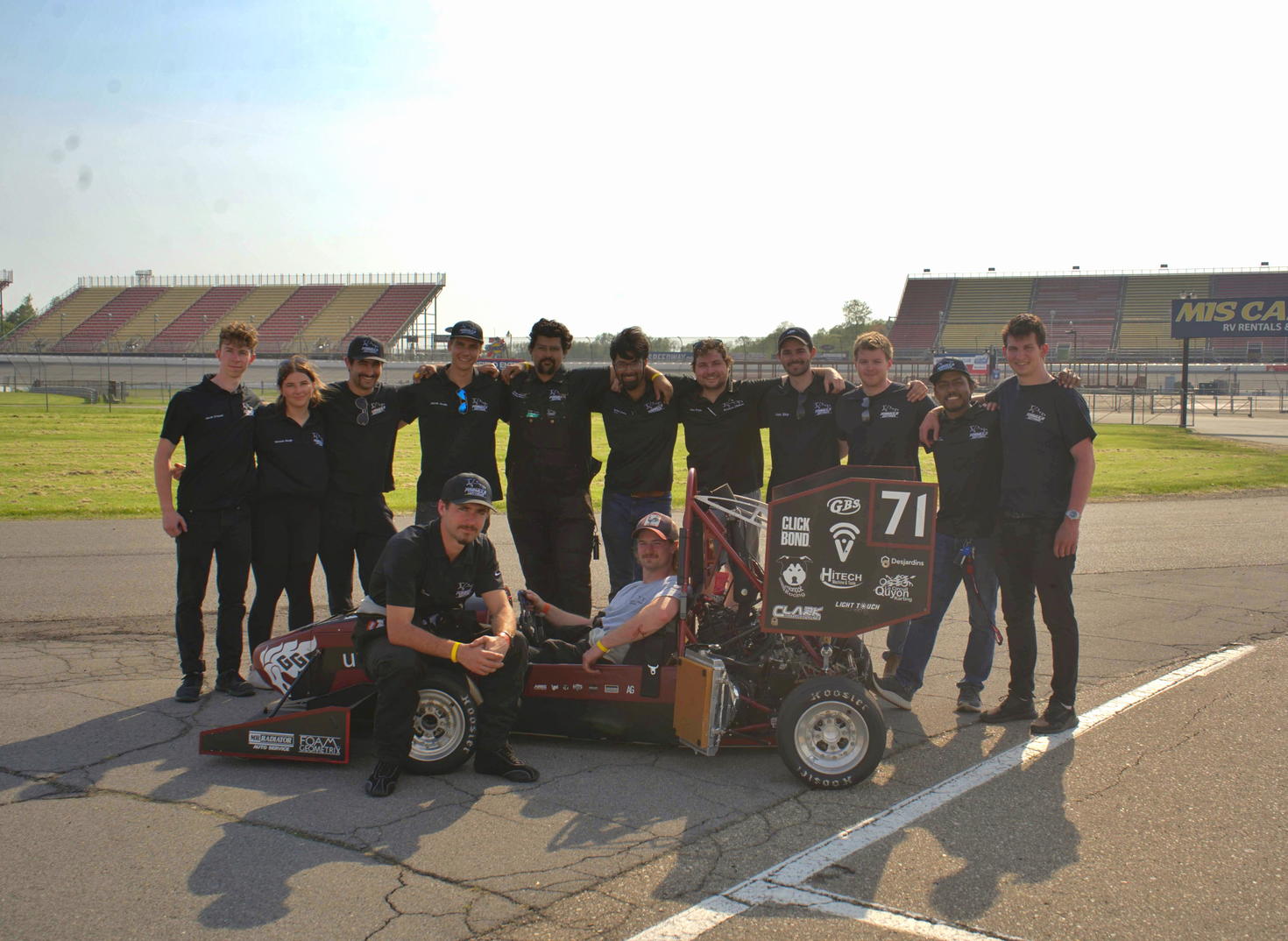 The members of the Formula uOttawa team with their car.