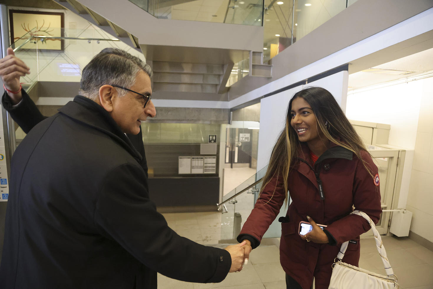 Justice Jamal greeting an enthusiastic student