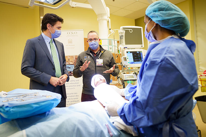 Dr. Glenn Posner showing Prime Minister Justin Trudeau around birthing simulation facilities. 