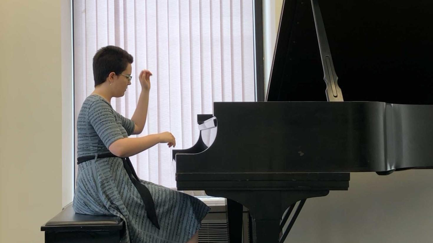 Annika Fabbi, sitting at the piano during a recital.