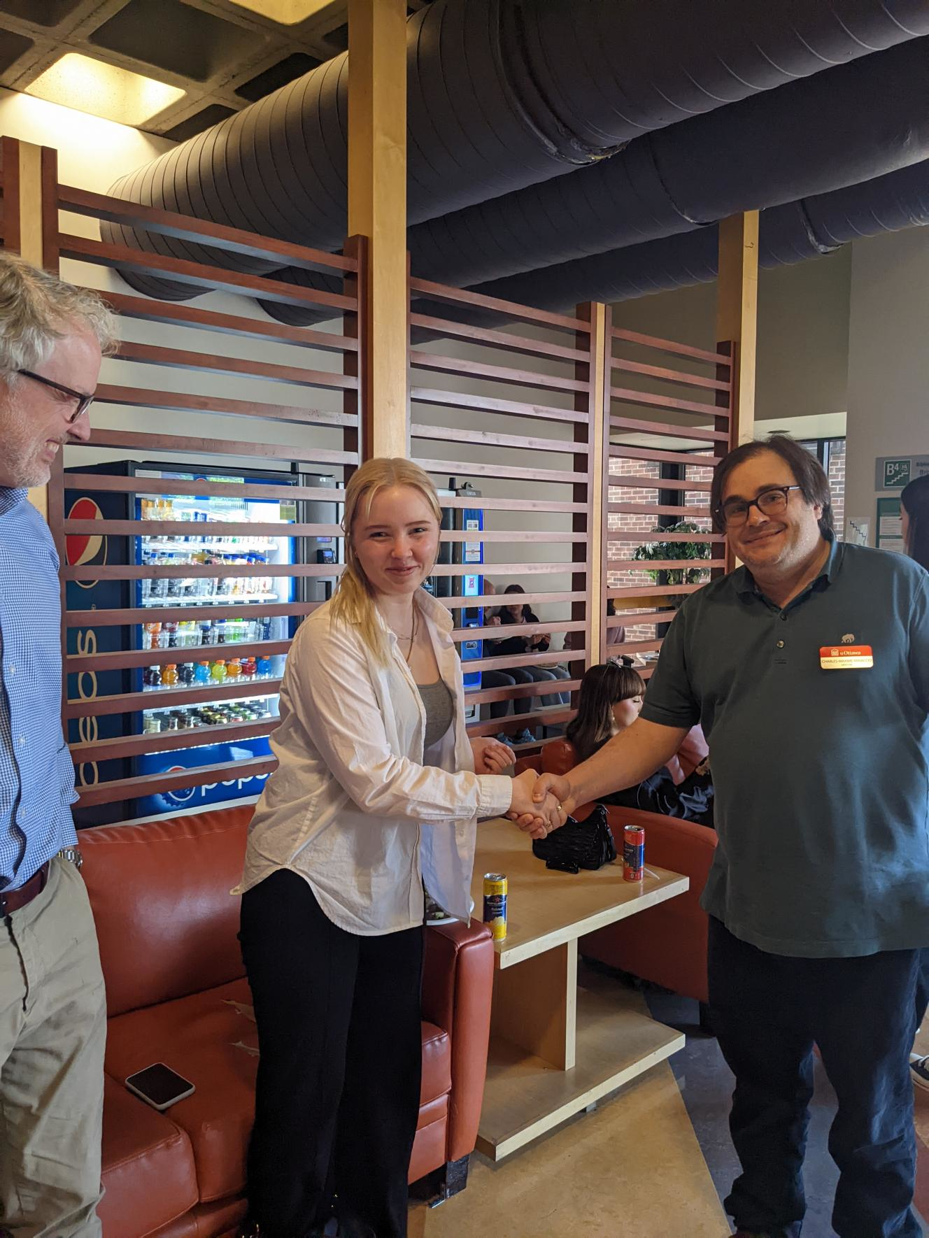 Un étudiant et un professeur se serrent la main