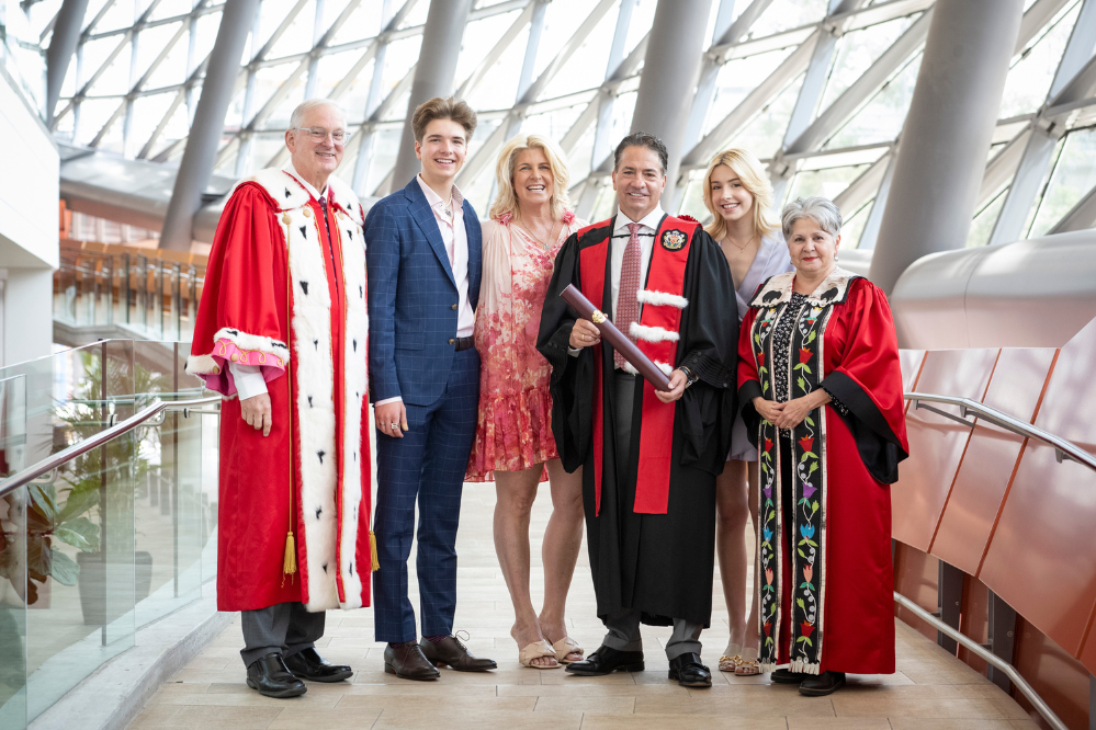 Perry Dellelce with his family and the President and Chancellor of uOttawa