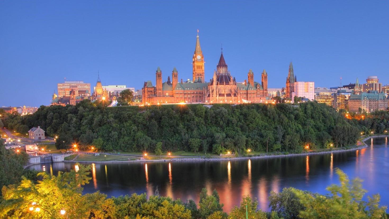 Parliament buildings of Canada lit up at night seen from Major hill park