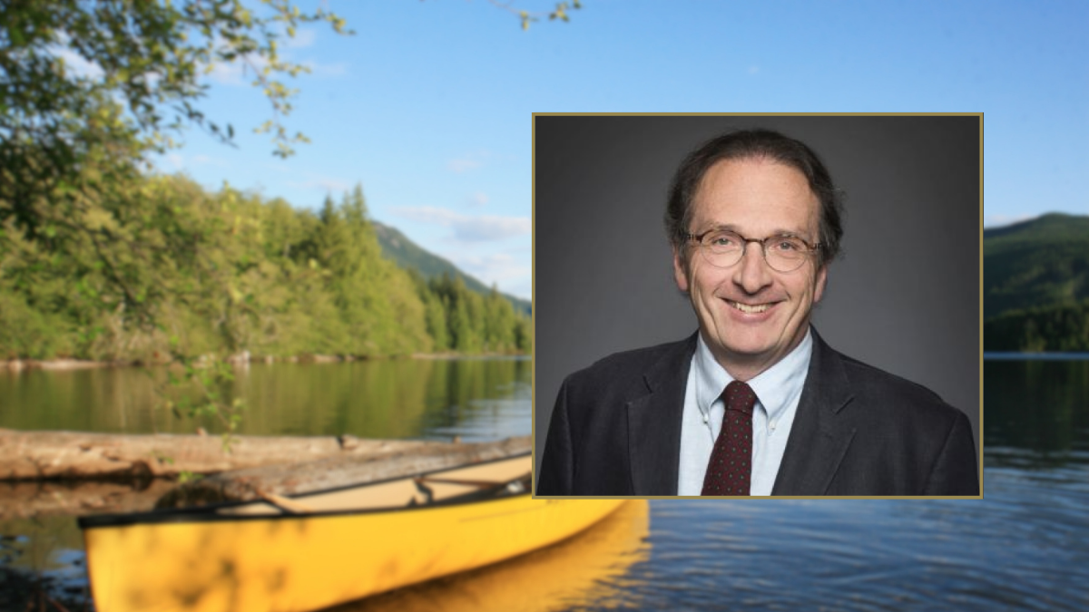 Jamie Benidickson on a background with lake and canoe