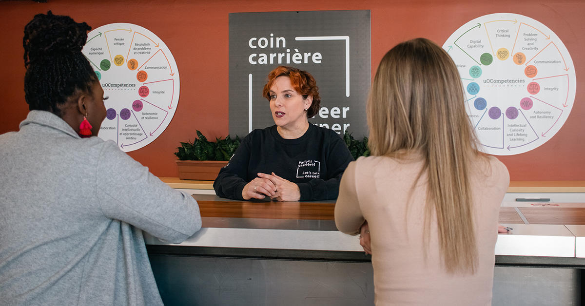 Employee talking to students about uOcompetencies