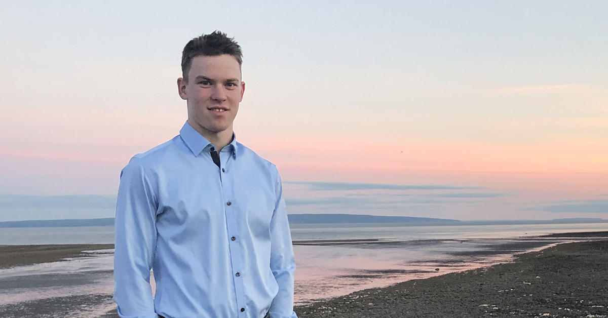 Jeremy Leigh on a beach at sunset.