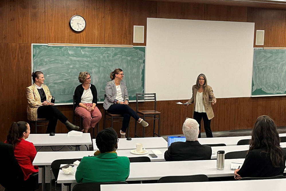 Danielle Mongeon, s'adressant à la classe, avec trois interlocuteurs assis derrière elle.