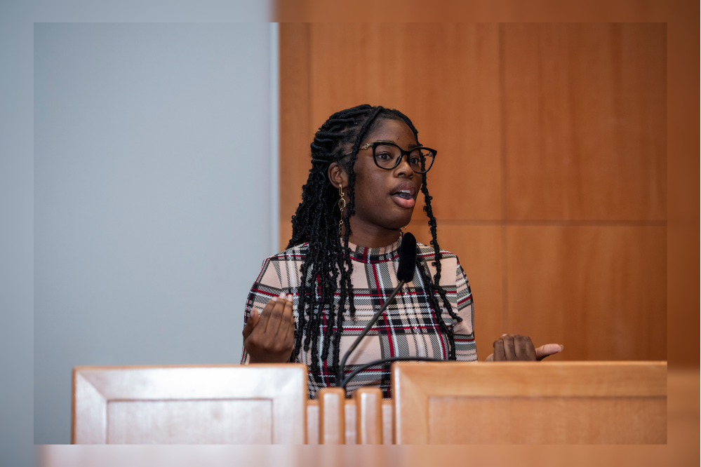 Timi Roberts speaking at the podium