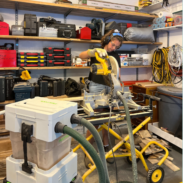 Student building little libraries in wood shop