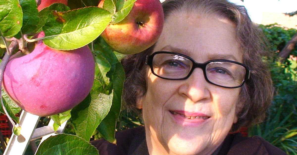 Portrait of Geraldine Arbach in an orchard