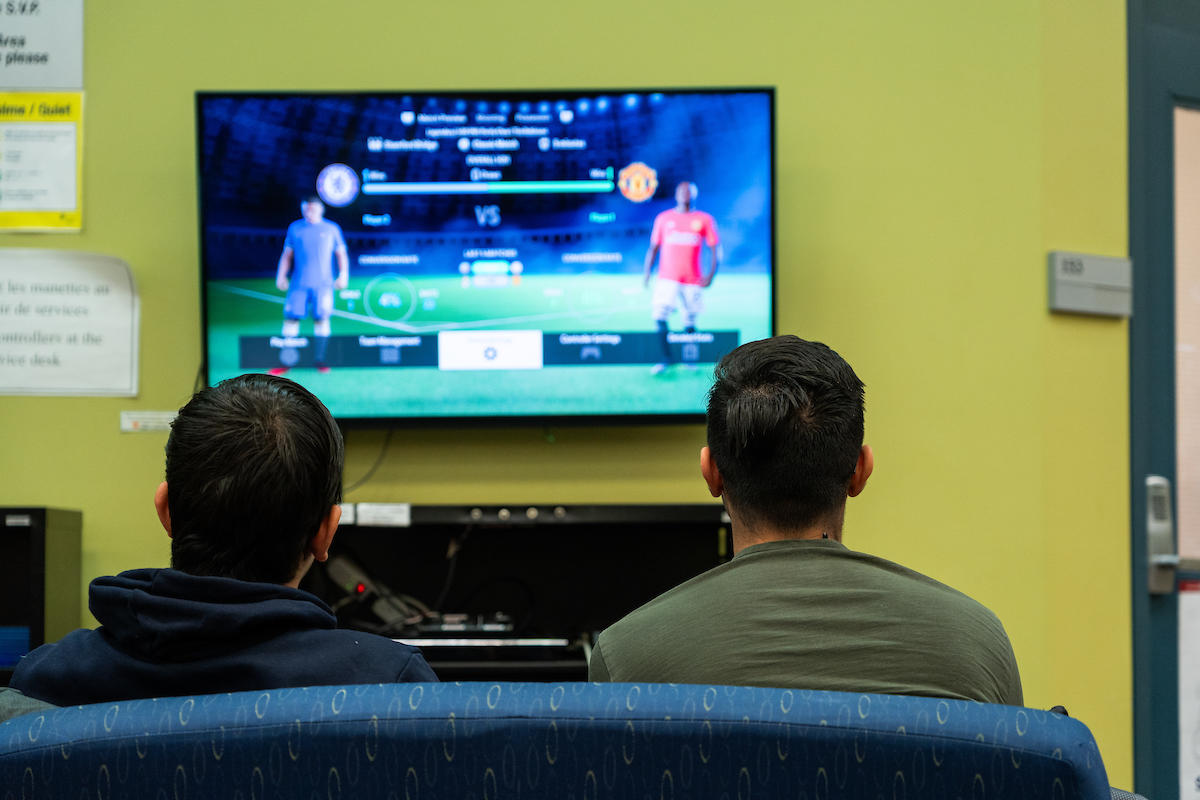 2 students playing Play station