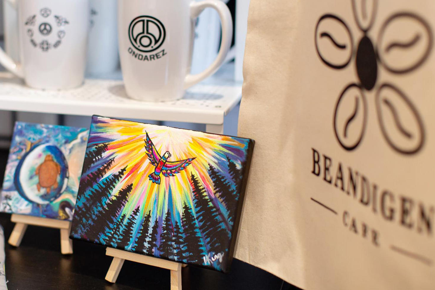 Beandigen cafe art, mugs and coffee beans.