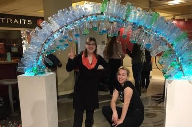 Victoria Rodgers and Emily Janek with their sculpture made from recycled water bottles.