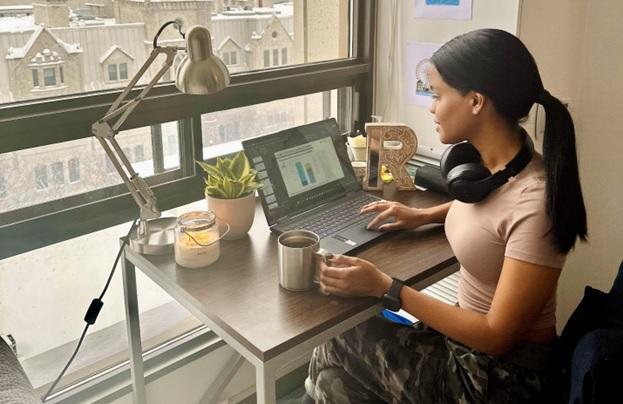 picture of Ryhan sitting at her computer in Ottawa