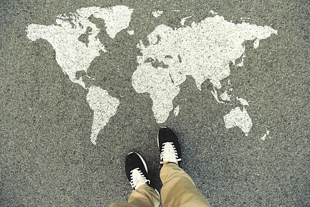 feet standing on world map