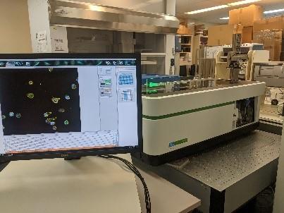 Opera Phenix with robotic arm delivering a microtiter plate