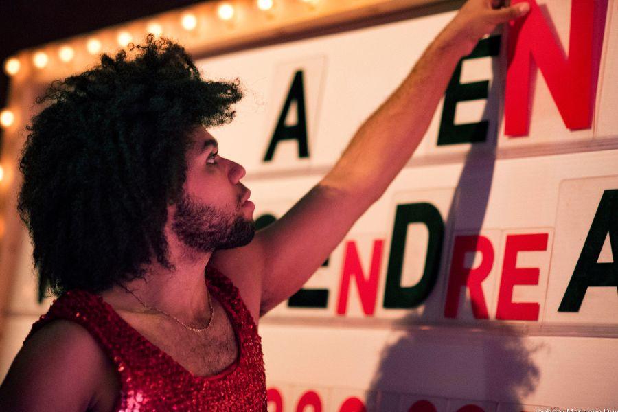 Person putting up a sign for an upcoming production. 