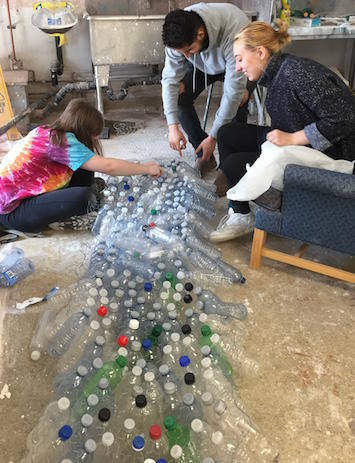 Victoria Rodgers, Ziad Salameh and Emily Janek with their sculpture made from recycled water bottles.
