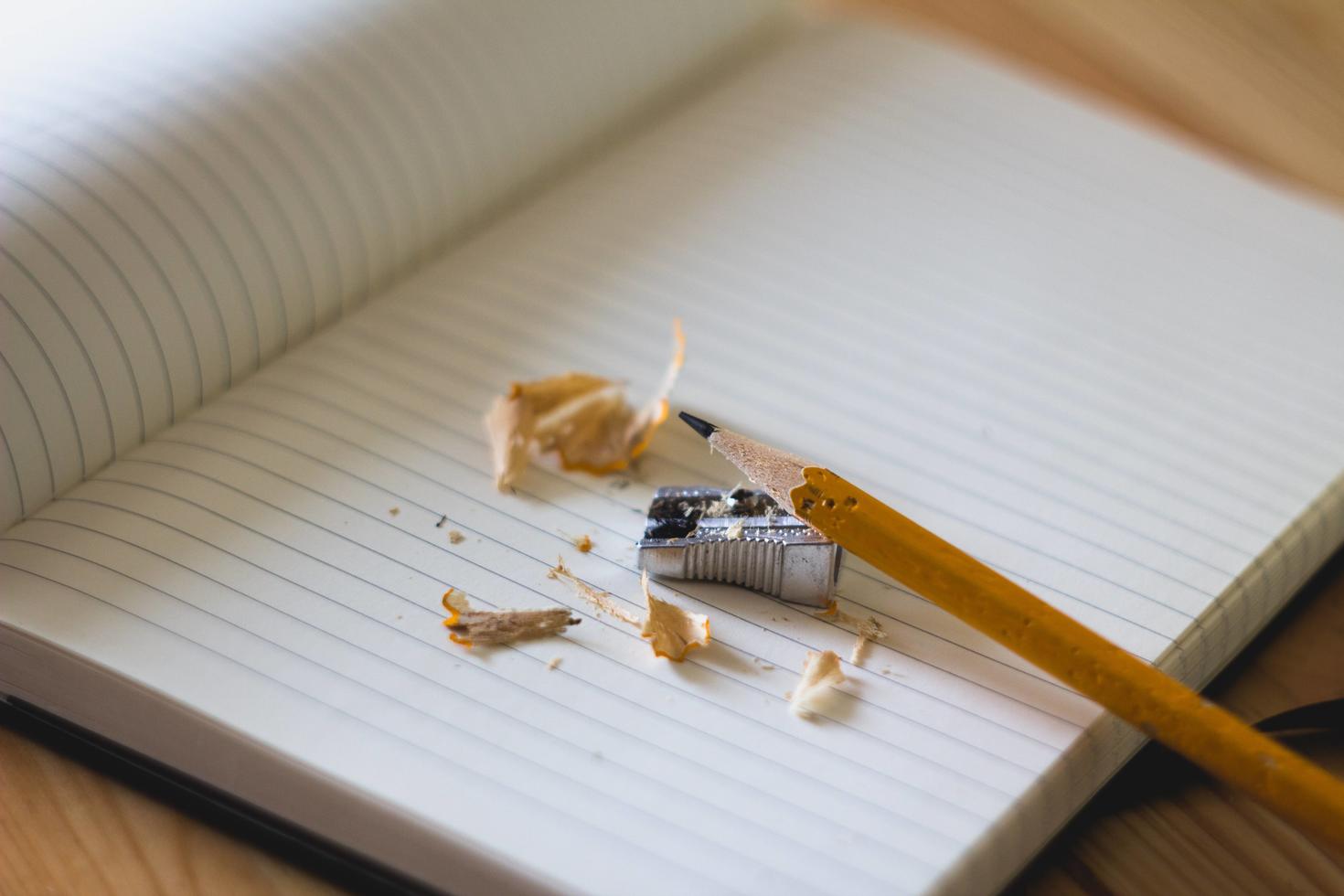 pencil and pencil sharpener on an empty notebook