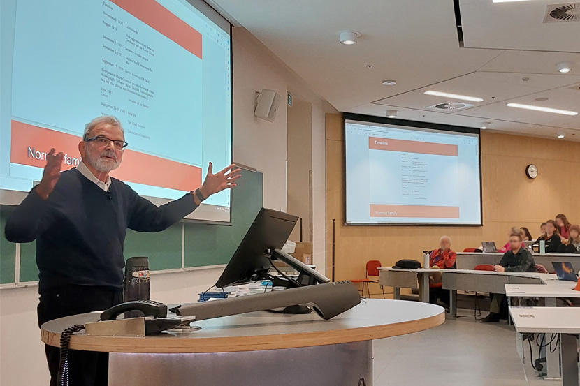 Professor speaking to students in a lecture hall