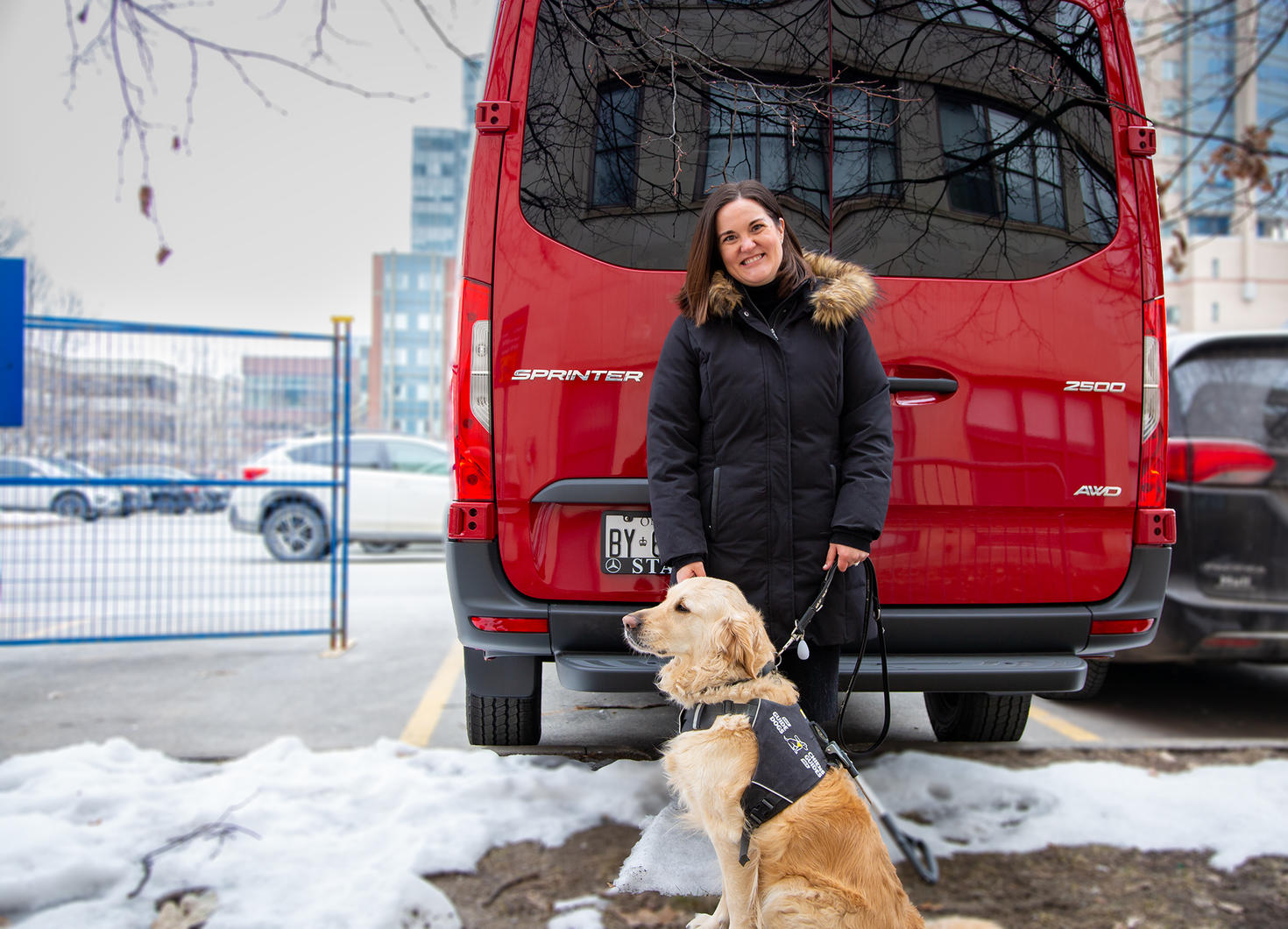 Erin Maloney standing by the Sprinter van that will serve as a mobile research lab.