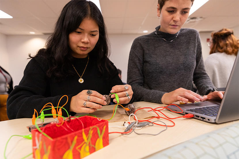 Teacher Education candidates with wires, donuts and a laptop.
