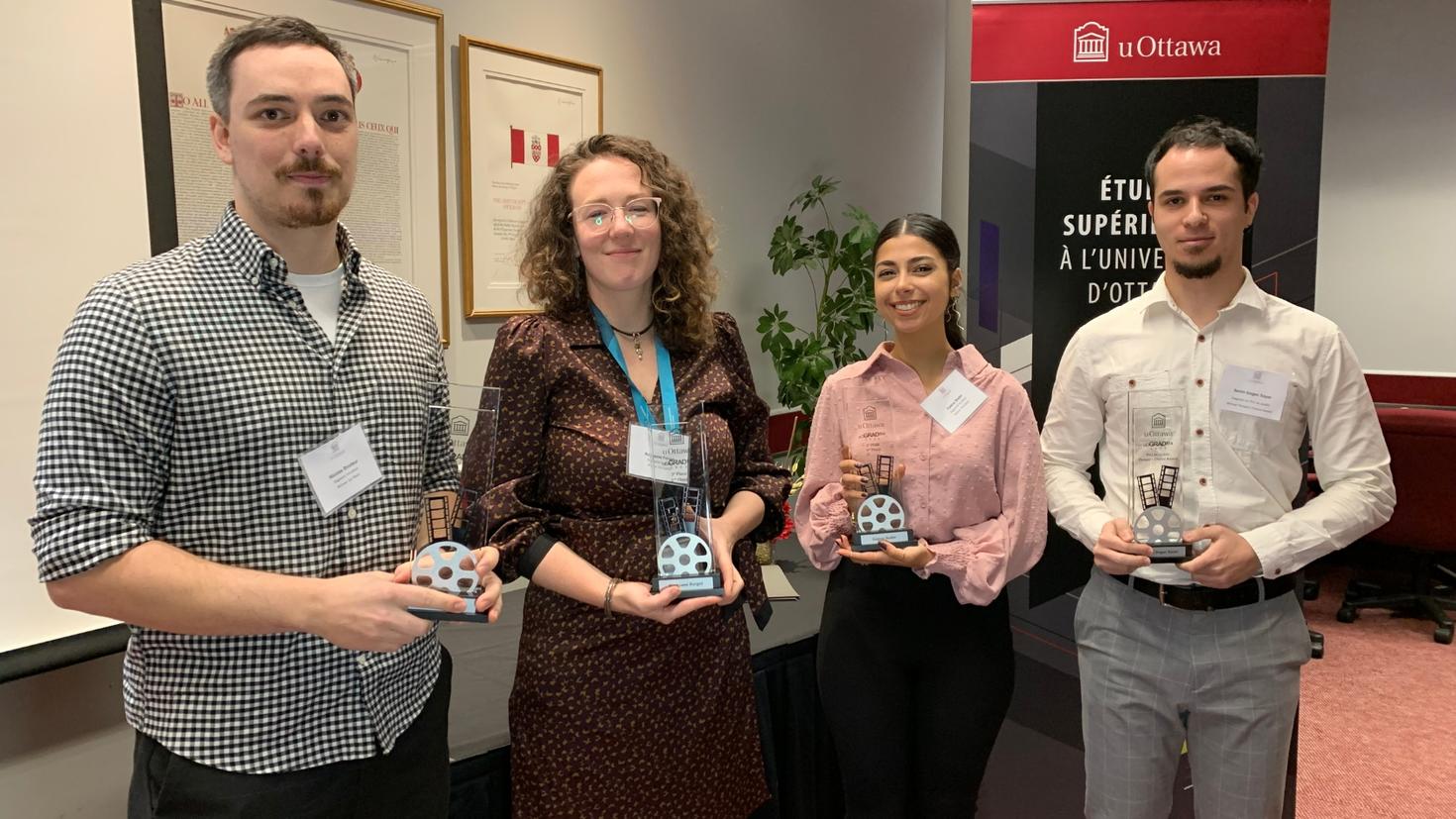 The four winners of the uOGRAflix contest holding their trophies. Nicolas Brodeur (first place) from uOttawa; Rocksane Forget (second place) from Saint Paul University; Fatène Bader (third place) from Saint Paul; and Serim Dogac Saya (people’s choice award), from uOttawa.
