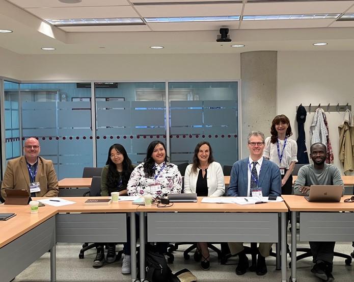 Small group of conference participants sitting at tables