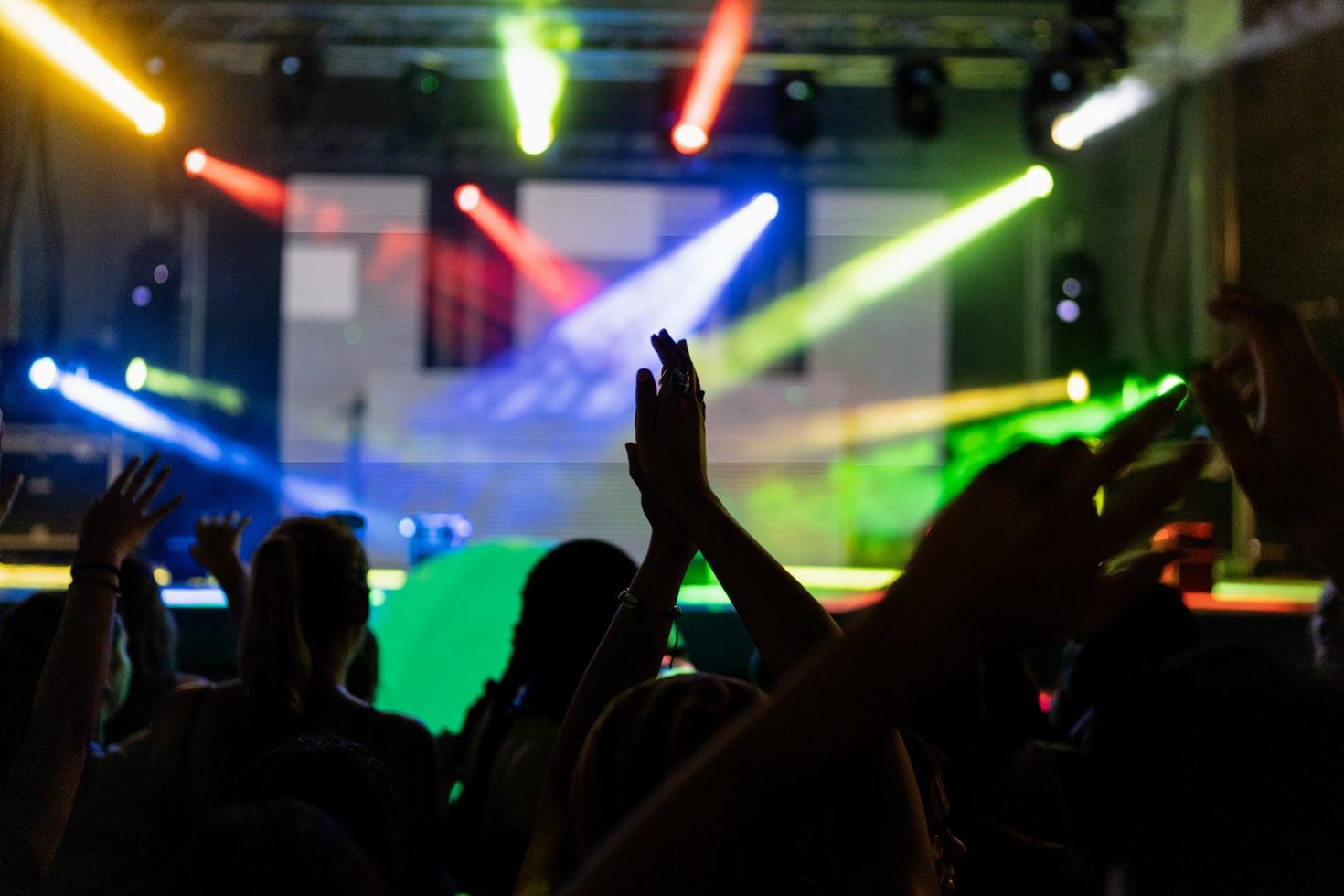 Students dancing with their hands in the air.