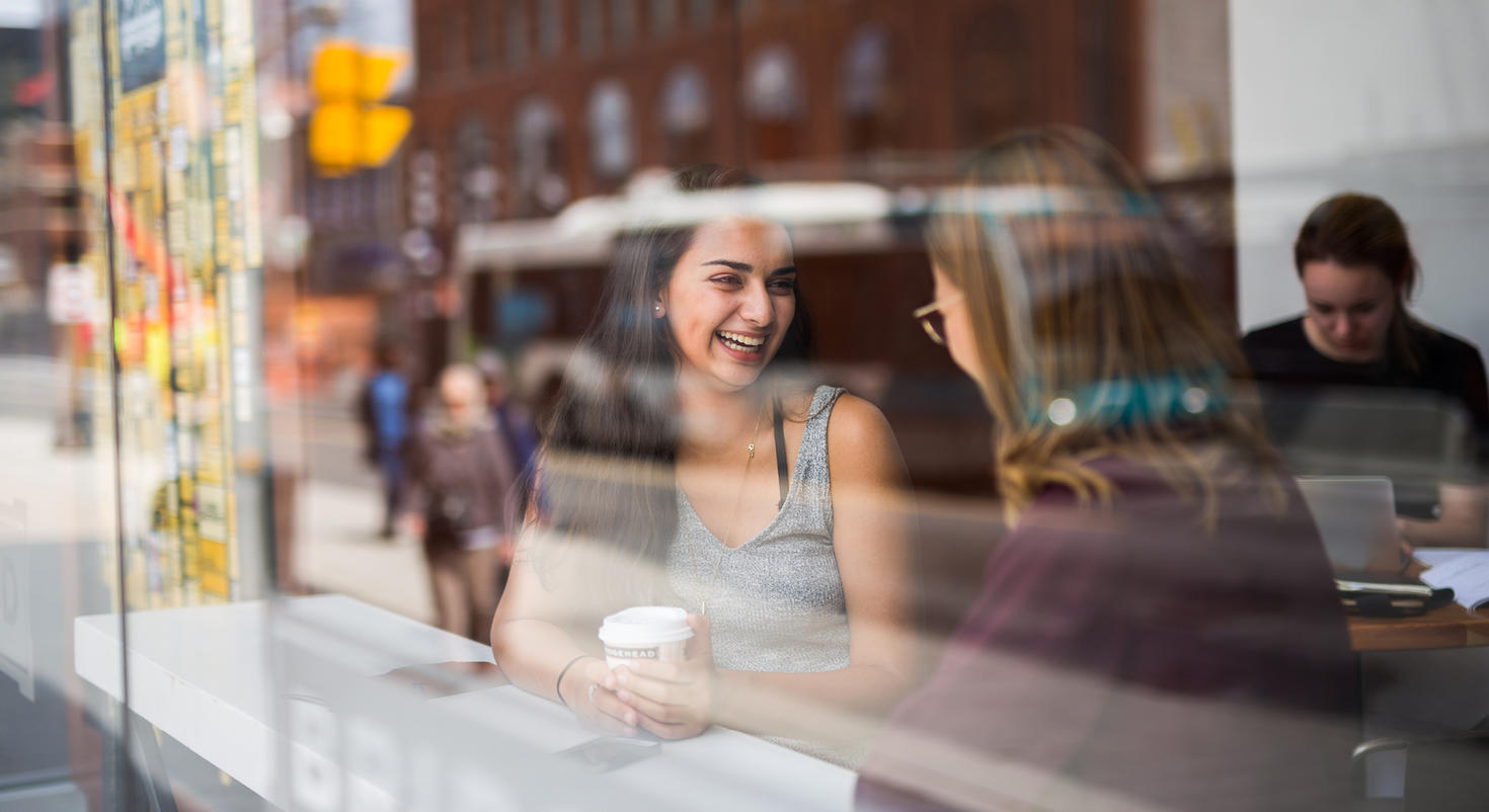 Two students sitting in a restaurant talking
