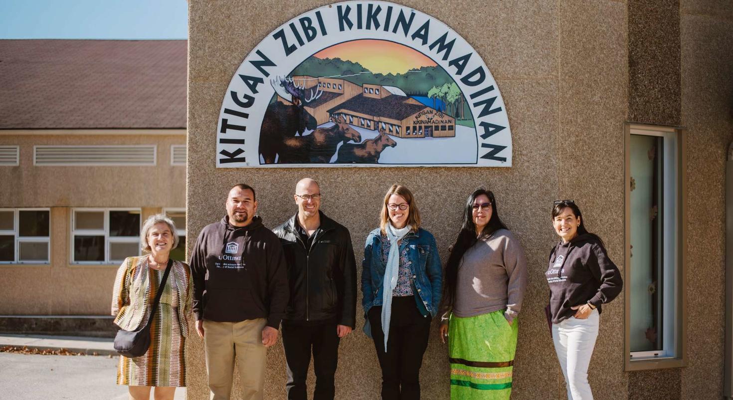group photo in front of the Kitigan Zibi Kikinamadinan