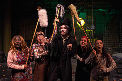 Five young students in a performance space.