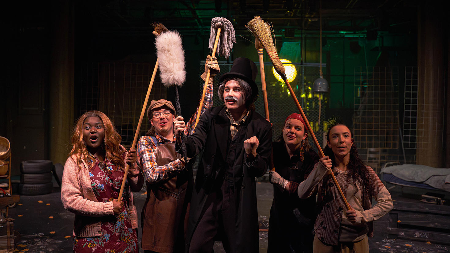 Five young students in a performance space.