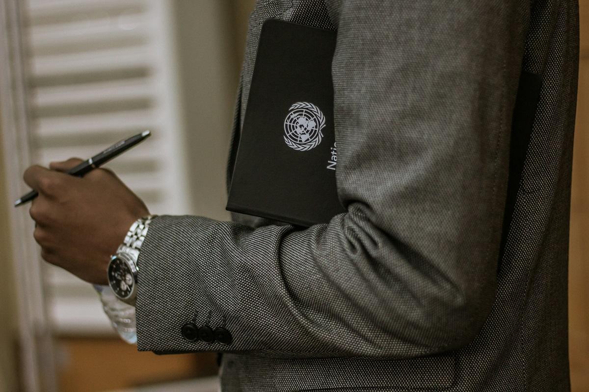 Person holding U.N. notebook