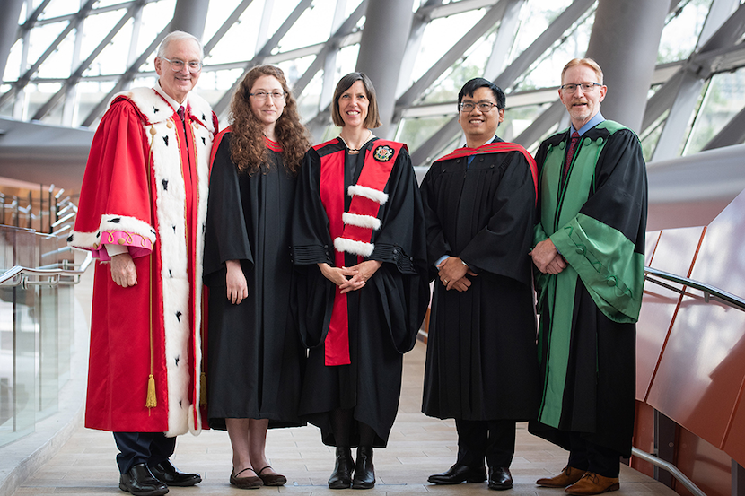 Five people standing in robes