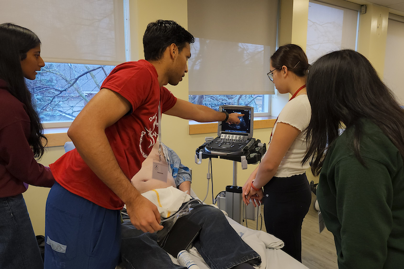 Students taking the vital signs of a volunteer patient