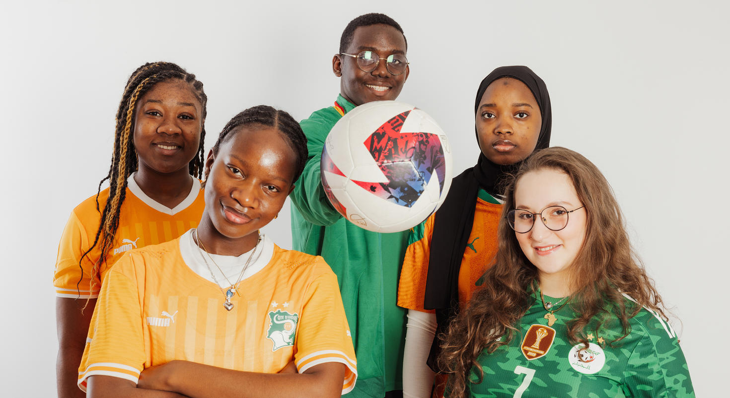 A group of five students from International House wearing soccer shirts during the Africa Cup of Nations.
