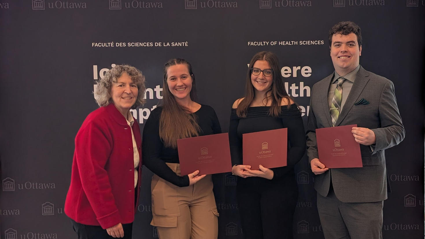 Dean Lucie Thibault with three student recipients of an Excellence award