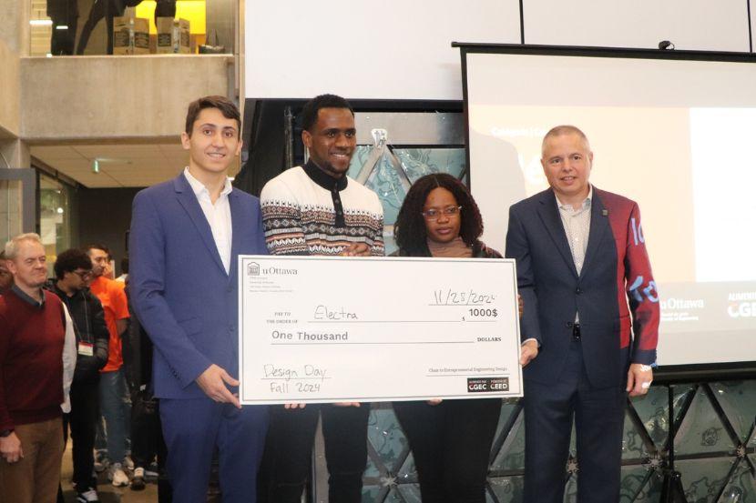 A group holding a prize money certificate.