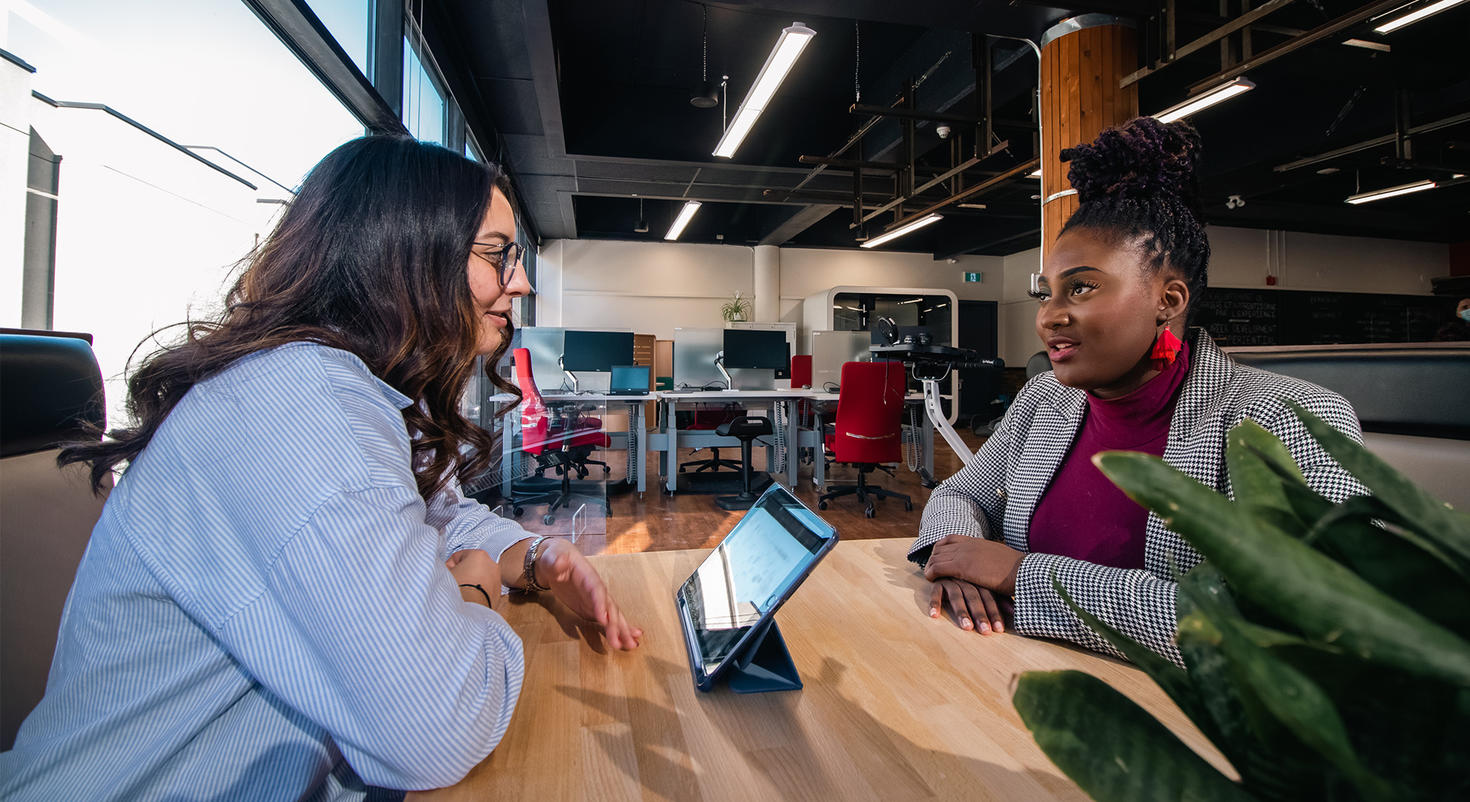 Two students sitting at a table inside the Career Corner.