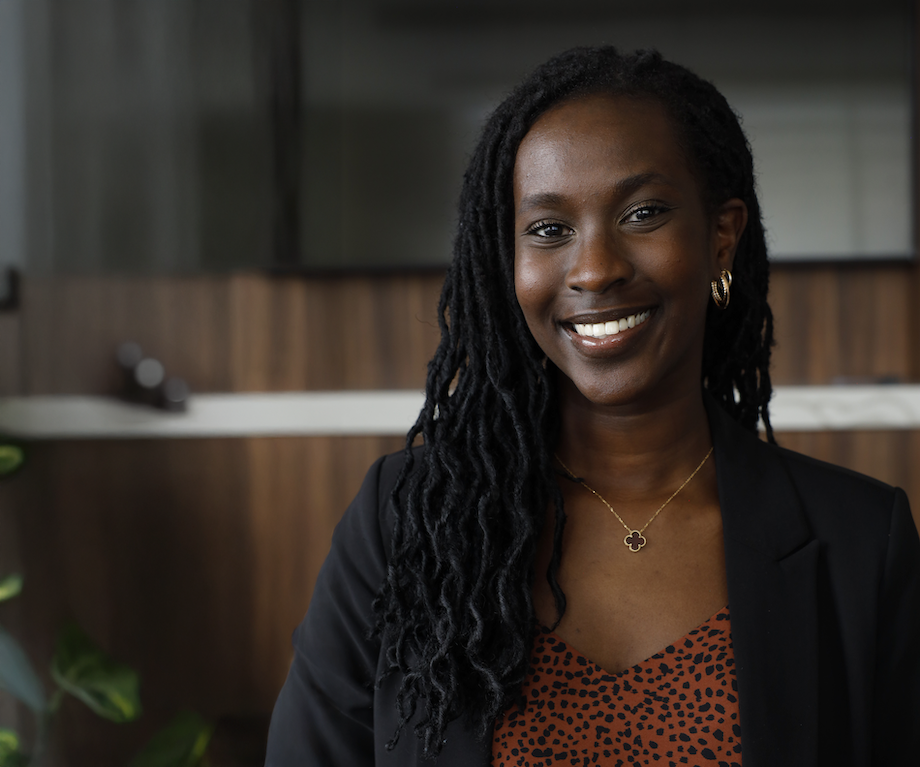 A medical student smiling in a board room