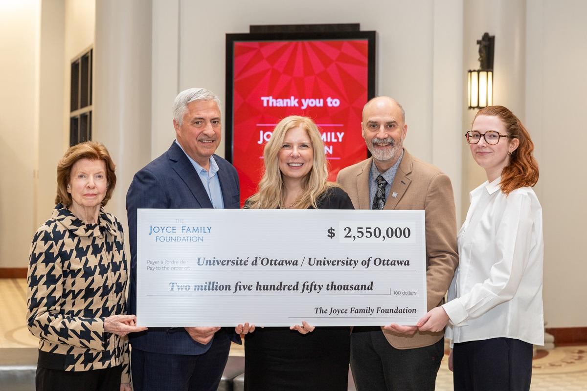 Picture of principal figures holding cheque