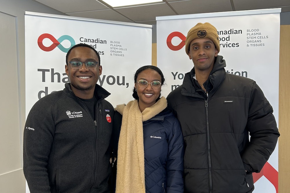 Three people smiling at the camera