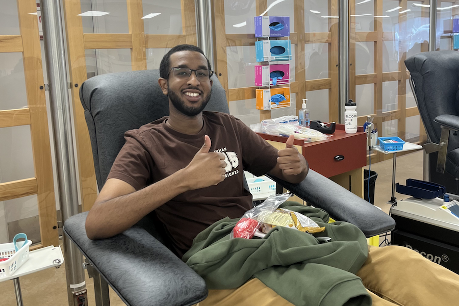 A blood donor gives a thumbs-up sign