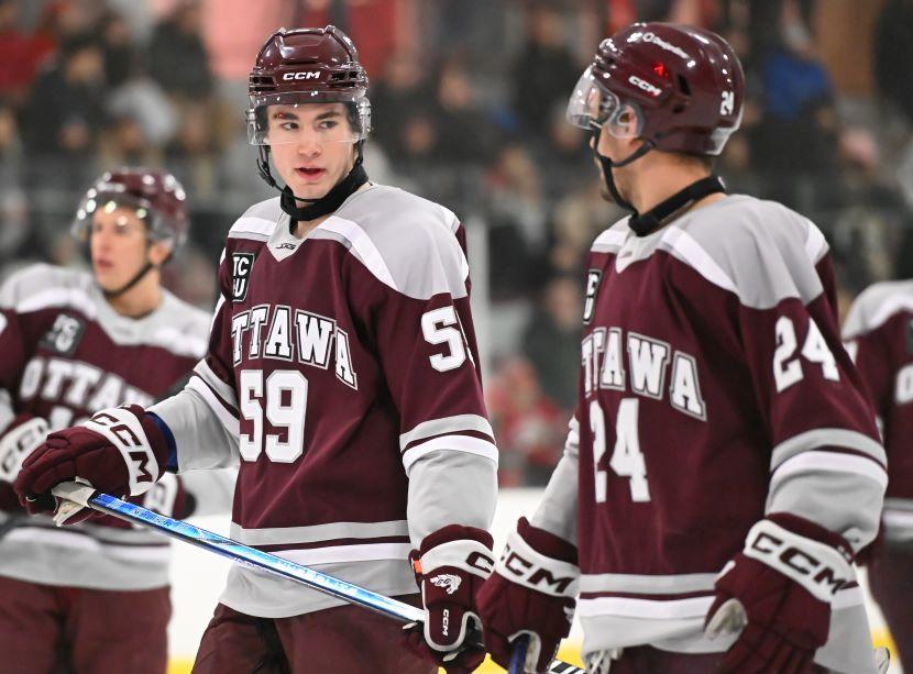 Brad Chenier and Mitch Martin share a look during a game.
