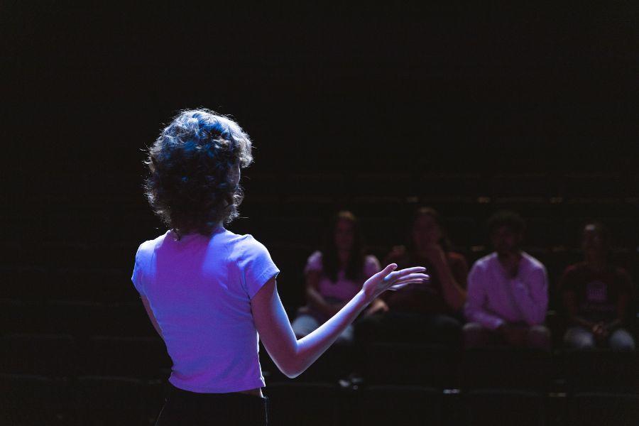 Student performing on stage.