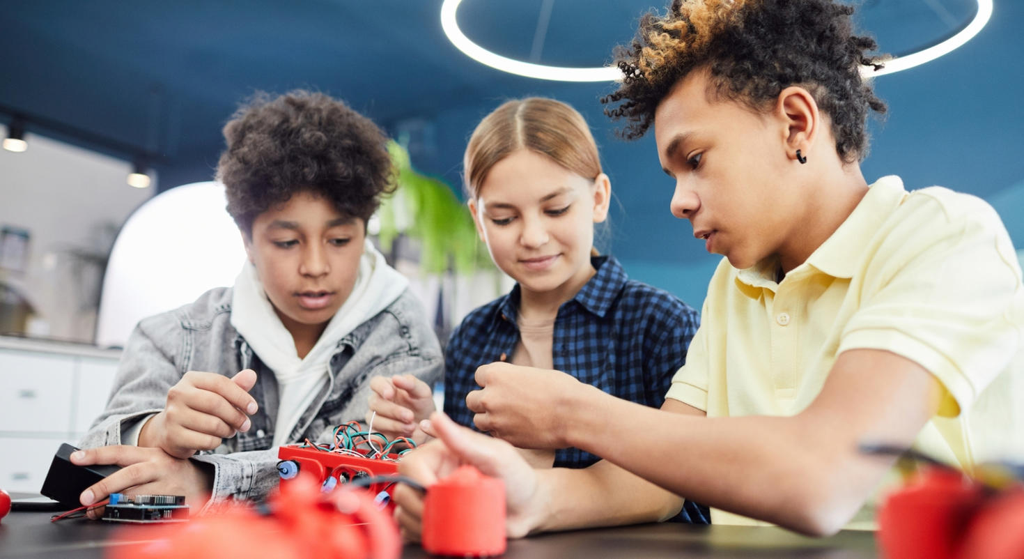 Three kids working with cables.