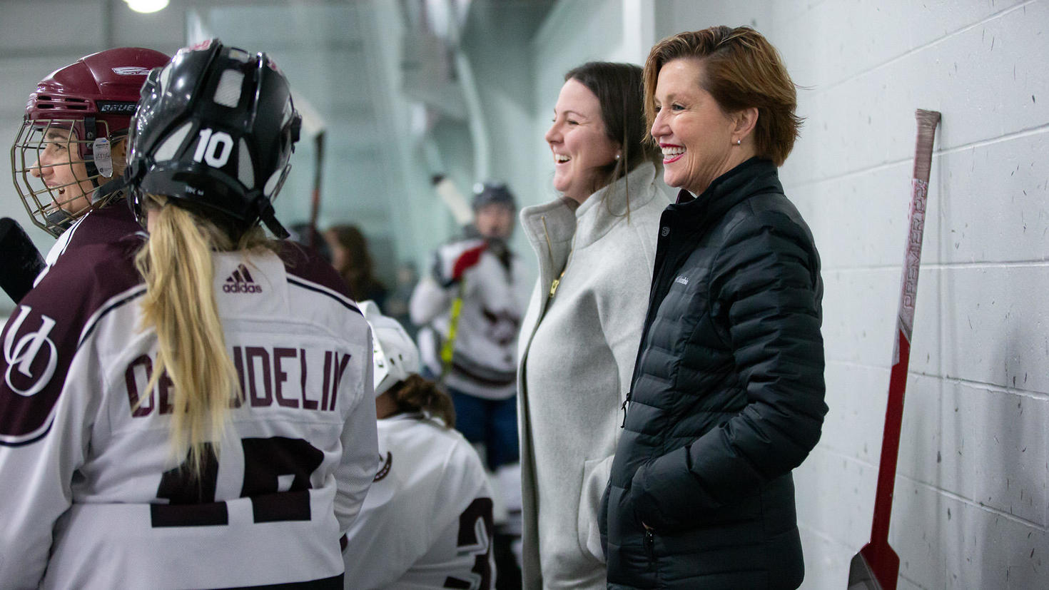 MK Marsden behind the bench Gee Gees women's hockey