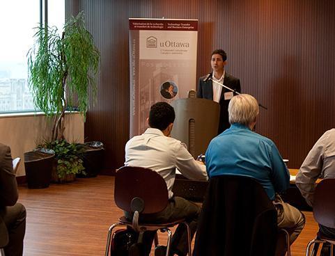 Someone at a podium speaking to an audience.