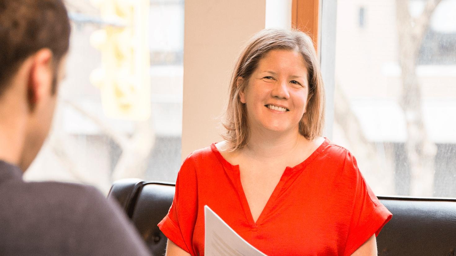 uOttawa alumnus Renée Black with documents. 